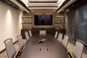 Modern conference room with long table and chairs.